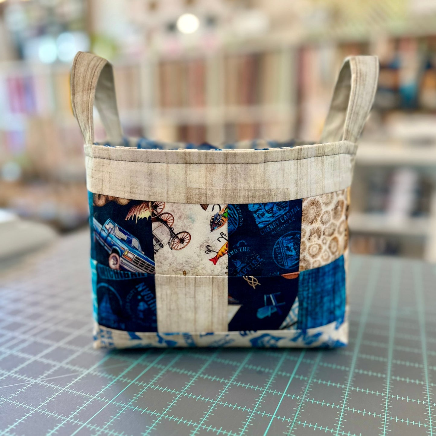 Patchwork fabric basket on a grid surface with a blurred background