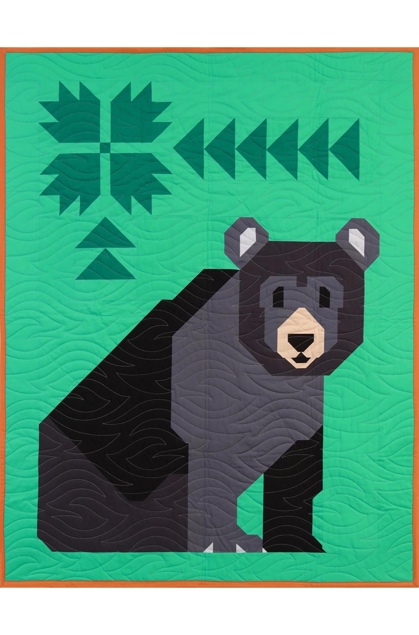 Quilt with a bear design on a green background