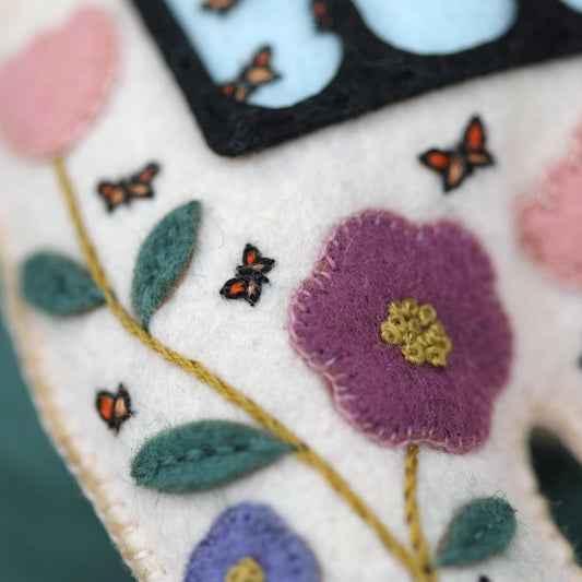 Close-up of embroidered fabric with flowers and butterflies