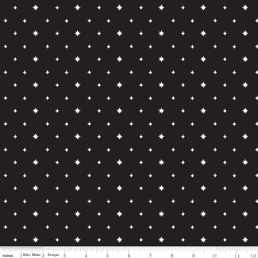 Black fabric with white star pattern and a ruler at the bottom for scale.
