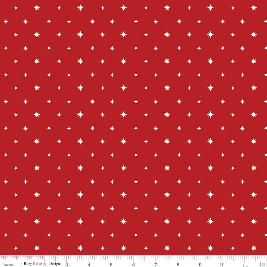 Red fabric with white star pattern and ruler at the bottom