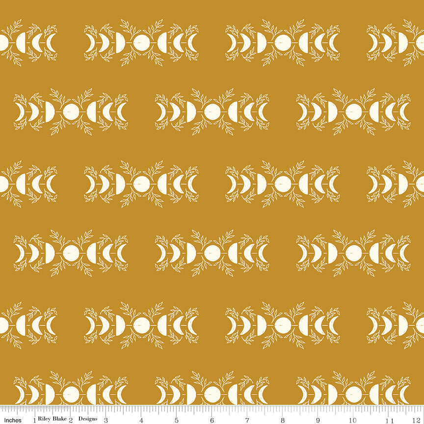 Patterned fabric with white design on a mustard yellow background