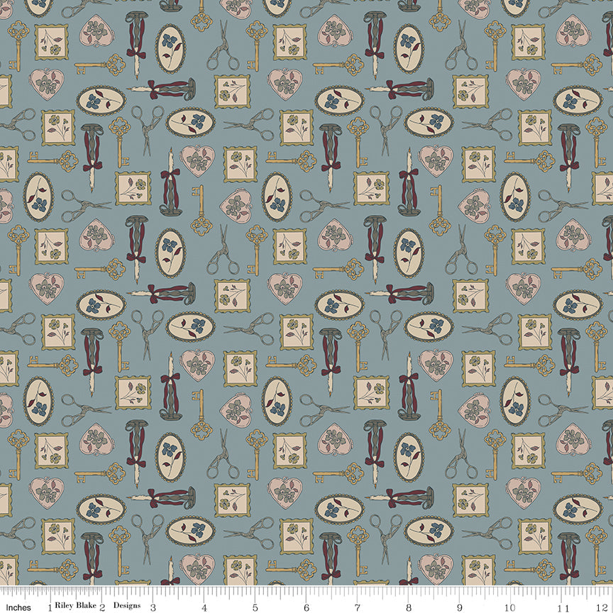 A repeating fabric pattern featuring vintage sewing tools and motifs, including scissors, thread spools, pattern books, and keys, in muted tones of dusty blue, beige, and brown. A ruler at the bottom indicates the scale of the print.