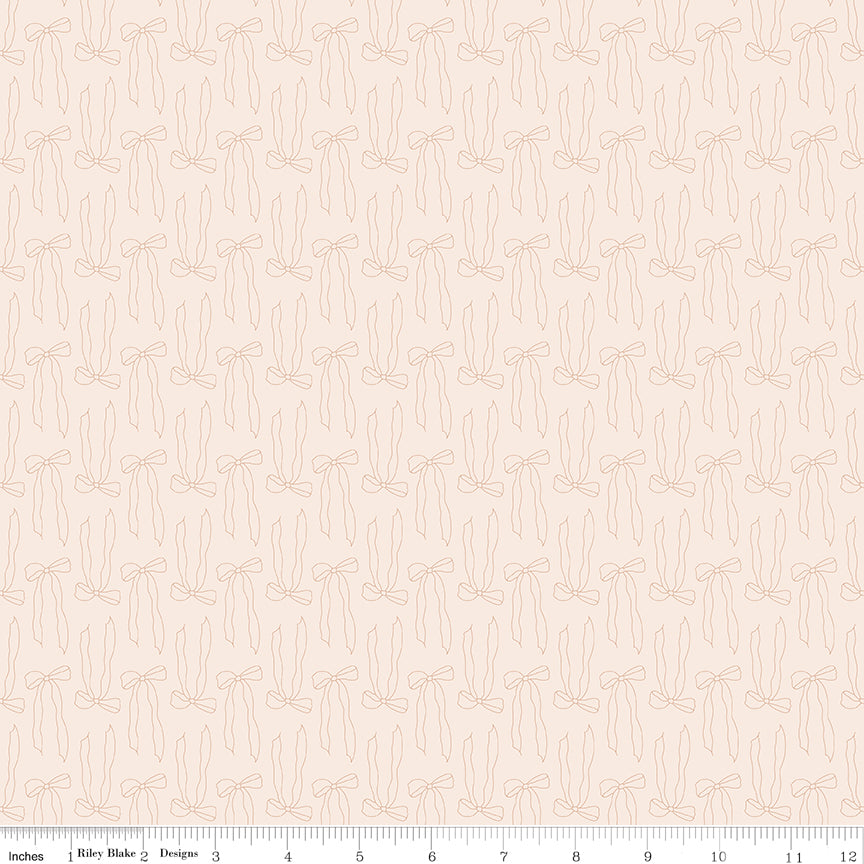 Patterned fabric with small bow design on a beige background