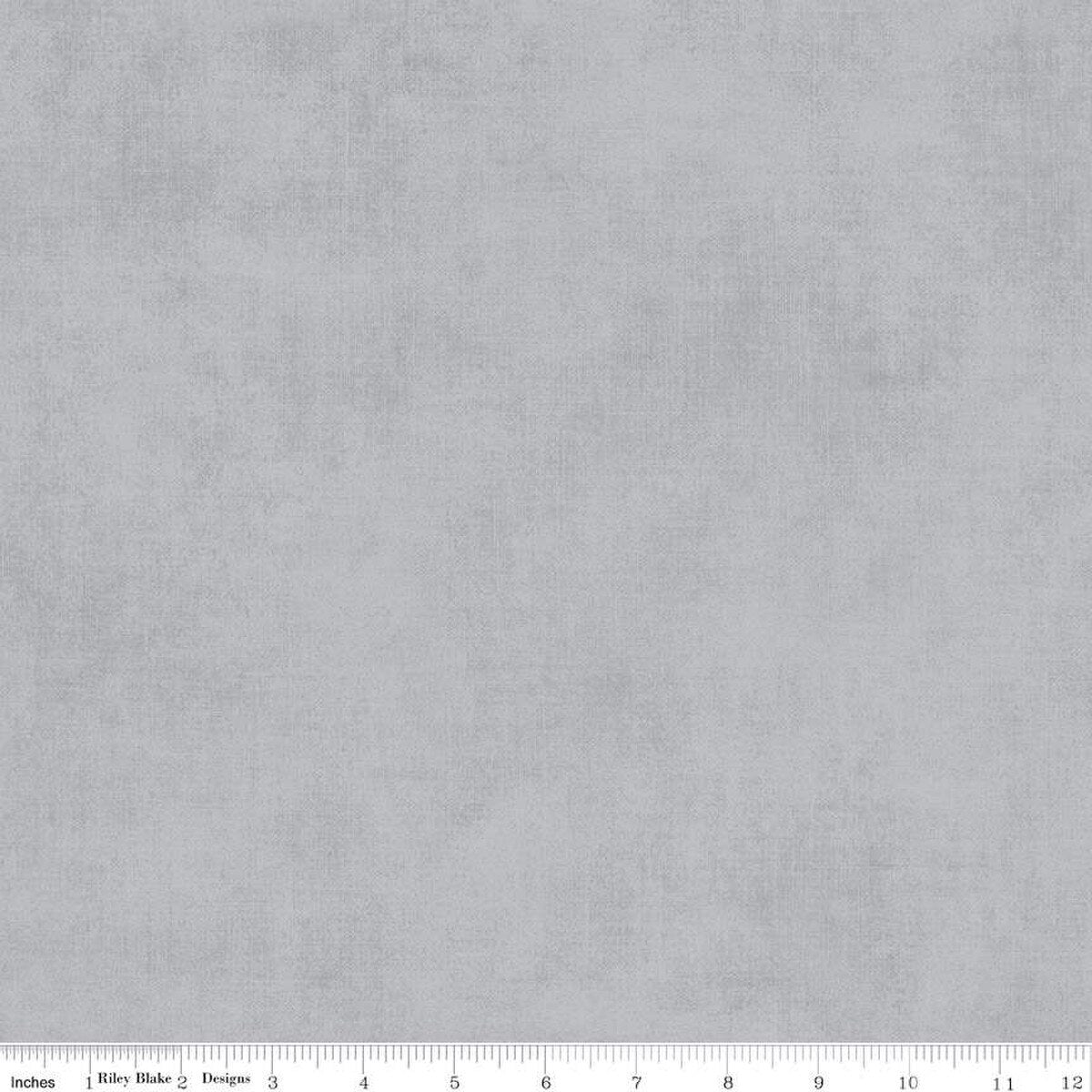 Solid gray fabric texture with a ruler at the bottom for scale.