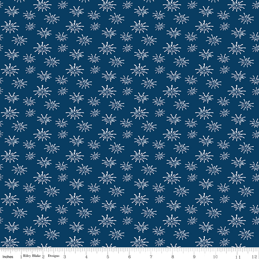 Blue fabric with white firework pattern, featuring a ruler at the bottom for scale