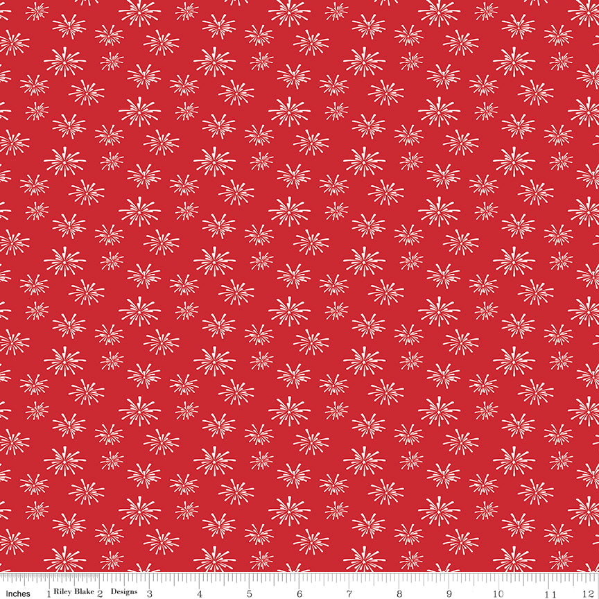 Red fabric with white firework pattern and ruler at the bottom