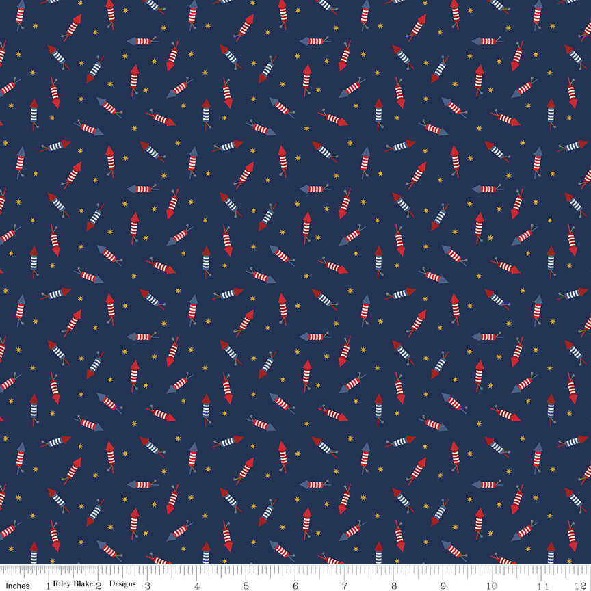 Pattern of small red and white striped rockets on a blue background with a ruler at the bottom.