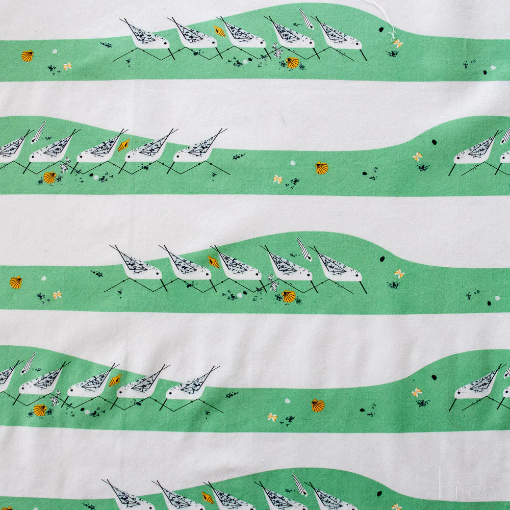 Fabric with a pattern of birds and green stripes on a white background