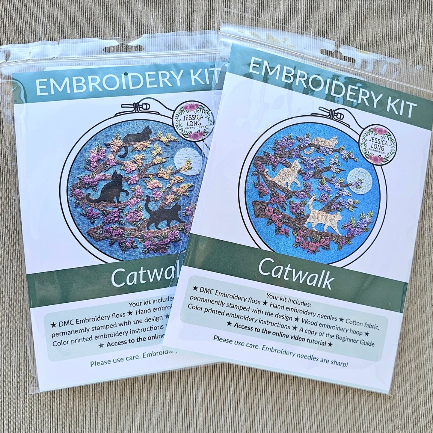 Two embroidery kits labeled 'Catwalk' on a wooden surface
