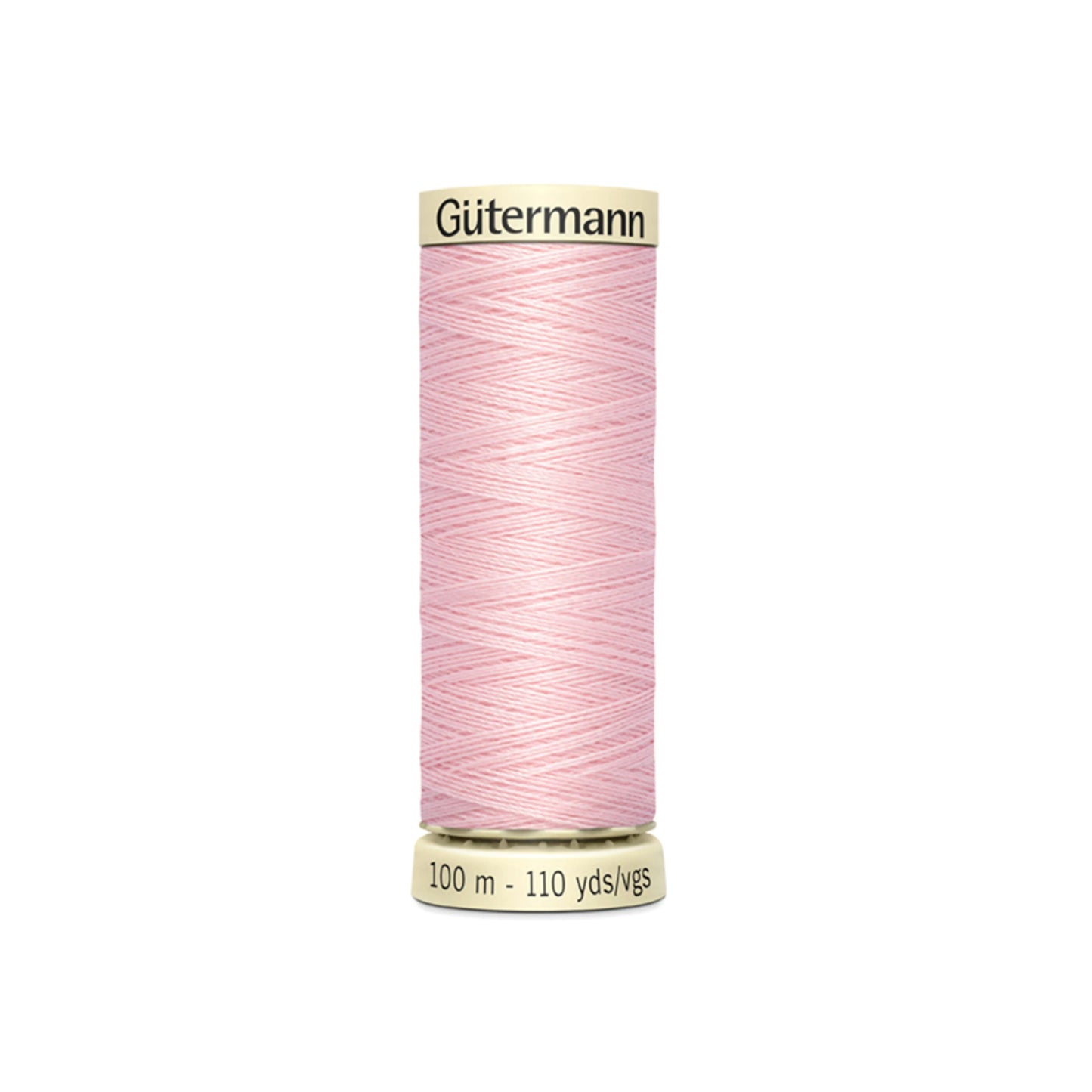 Spool of pink Gutermann thread on a white background