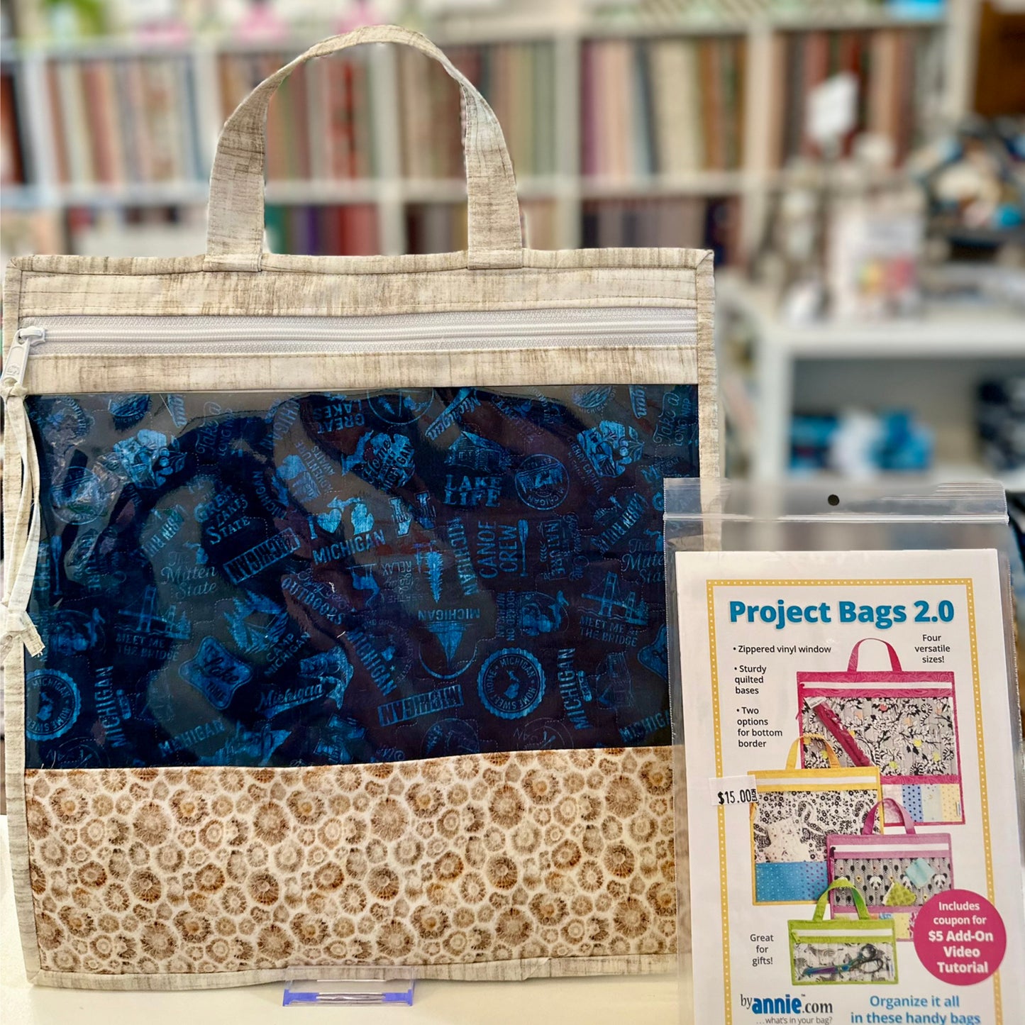 Fabric project bag with blue interior and floral exterior, displayed with a product card.