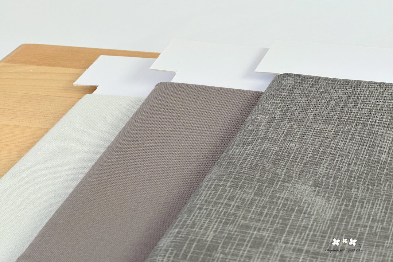 Quilters Linen Stone featured with Kona Cotton Solids Zinc and Dove