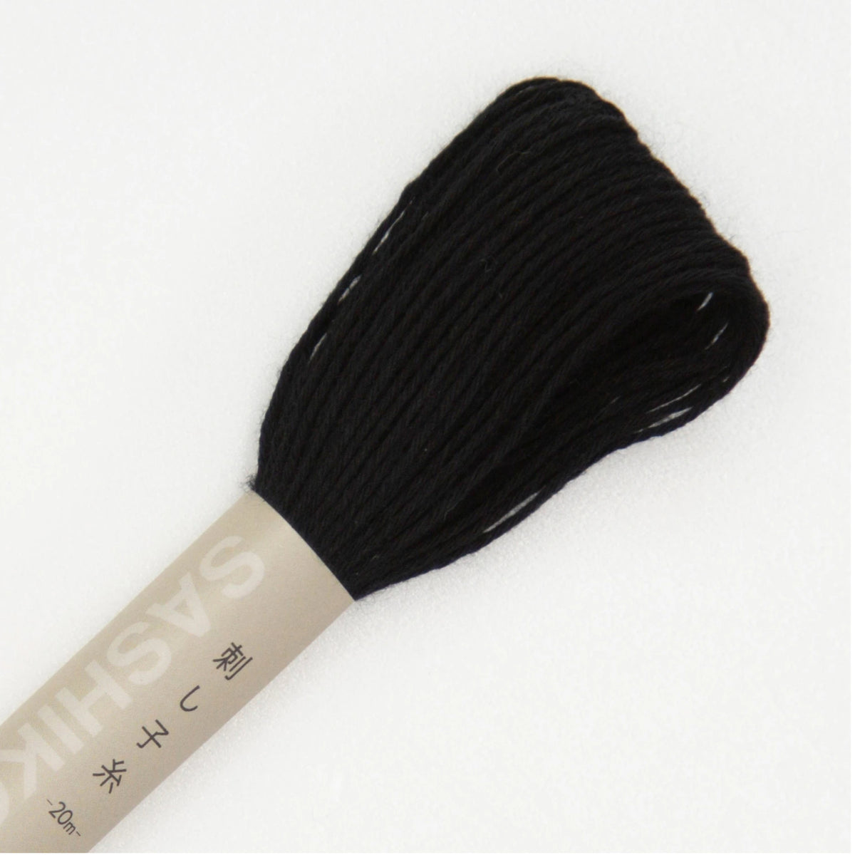 A bundle of black embroidery thread wound around a beige paper spool, shown on a plain white background.