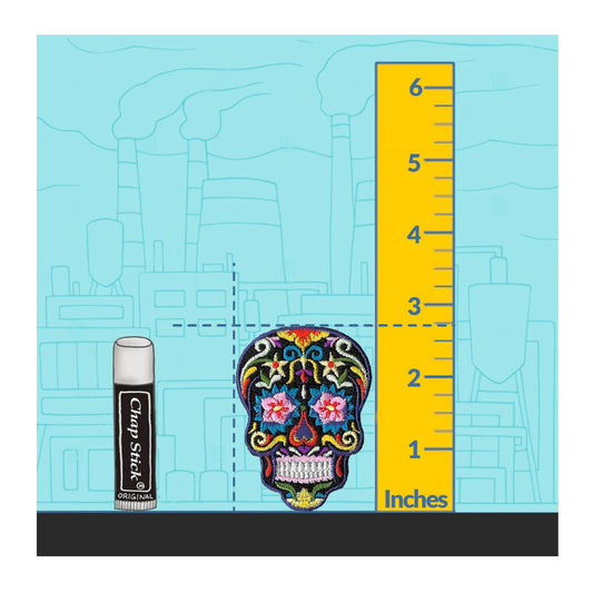 Colorful sugar skull design with a ruler and Clam Stick can on a blue background
