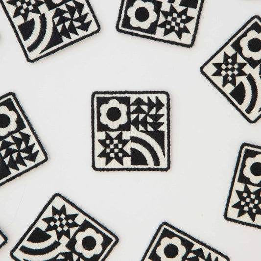 Pattern of black and white geometric designs on a white background