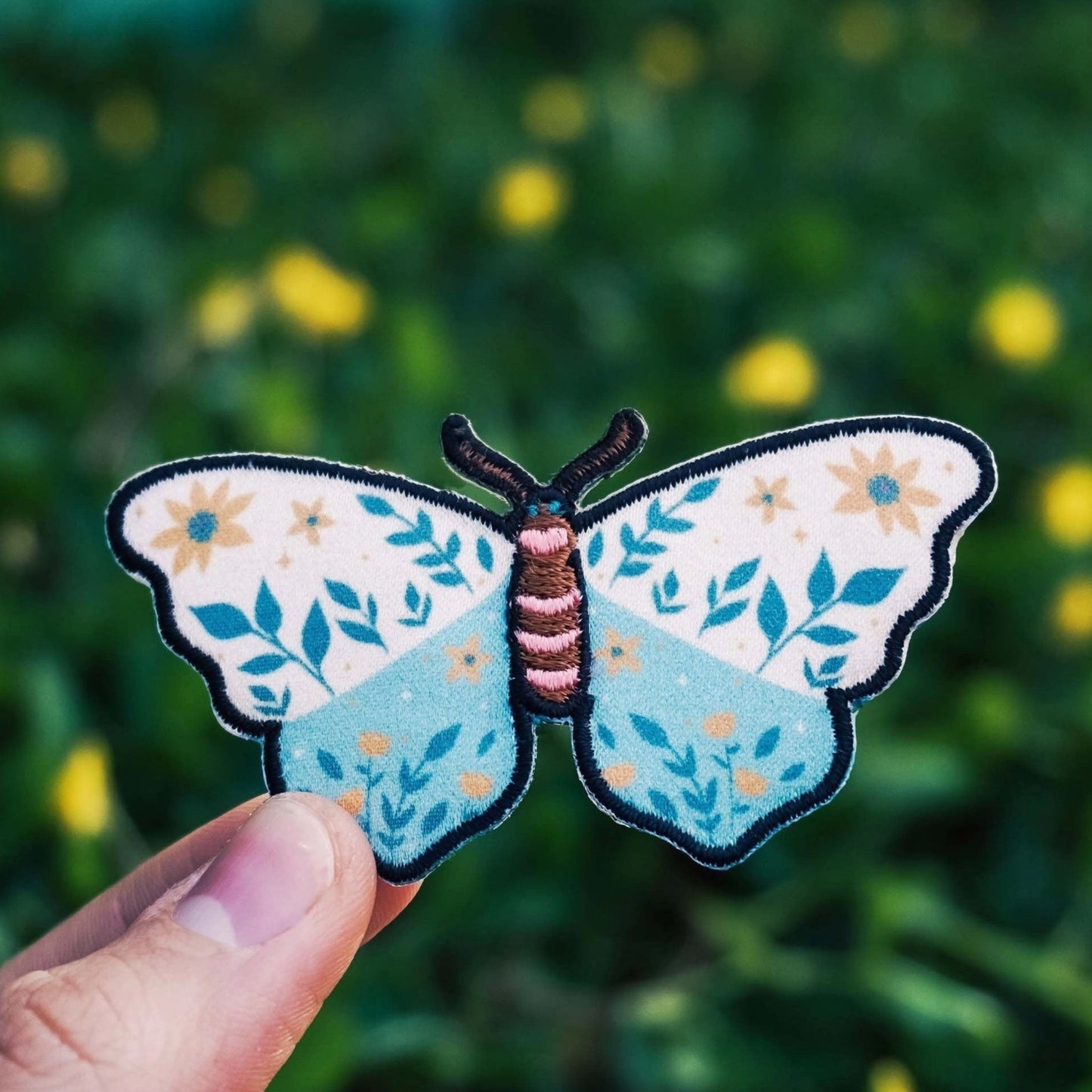 Moth Patch being held for size reference
