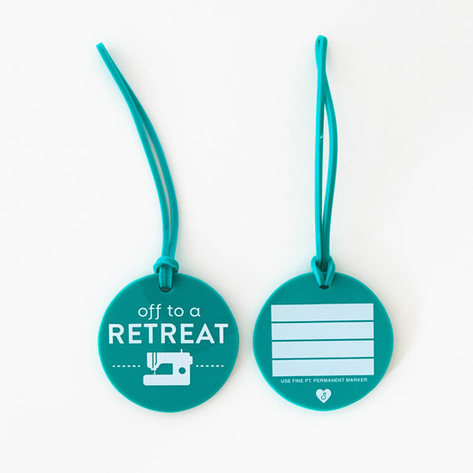 Two teal luggage tags with text and a sewing machine icon on a white background