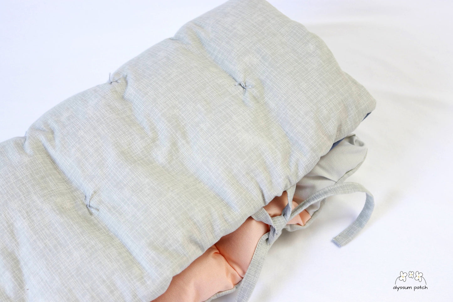 sunrise patchwork puff seat cushion folded and secured with ties for easy transport