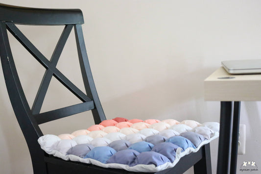 Sunrise Seat Cushion in use on a hard chair