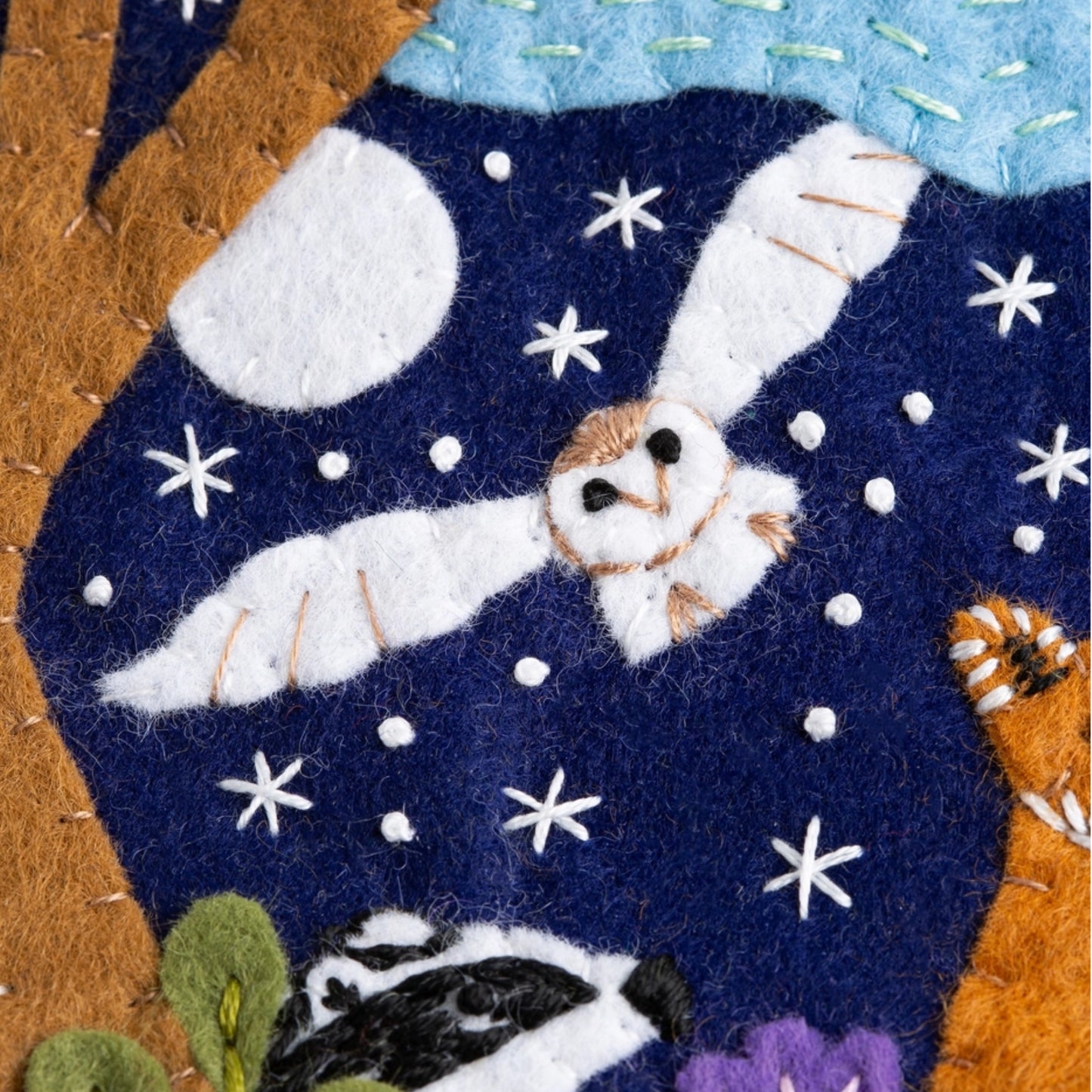Close up of embroidered Woodland Pennant Felt Craft Kit