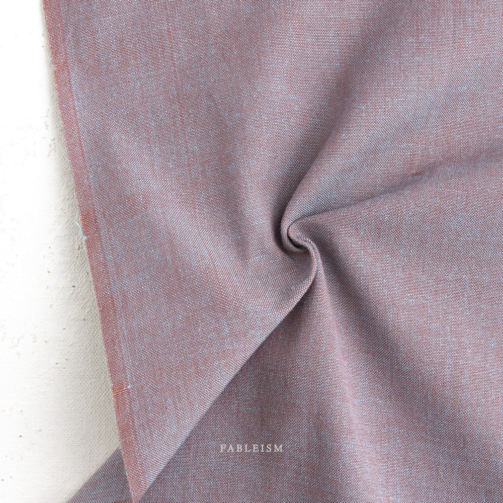 Close-up of textured fabric with a brand name 'Fableism' at the bottom.