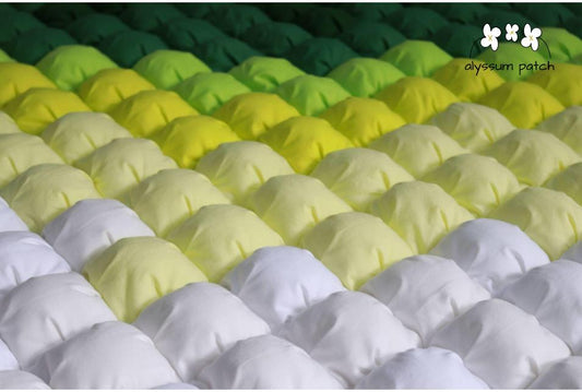 Close up of Citron Patchwork Puff Quilt