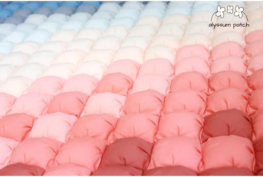 Close up of sunrise patchwork puff quilt