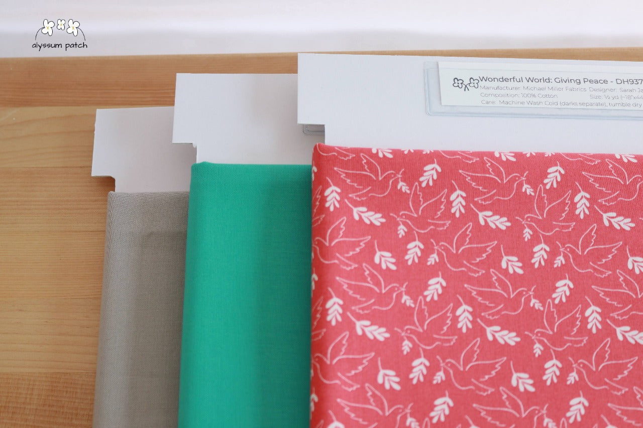 Giving Peace precut fabric paired with Kona Solids Candy Green and Kona Solids Zinc