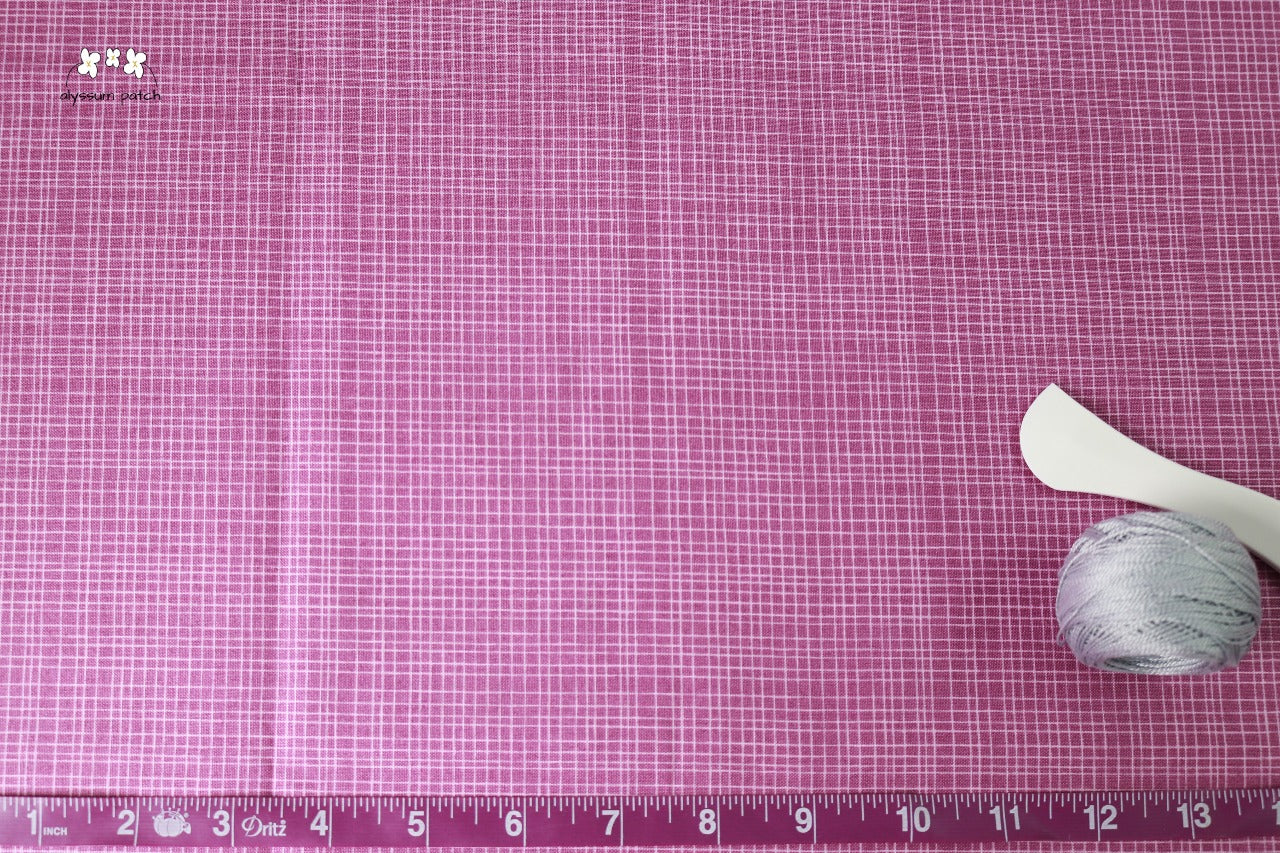Wildberry Woven fabric with tape measurer and sewing tools to show scale of pattern image