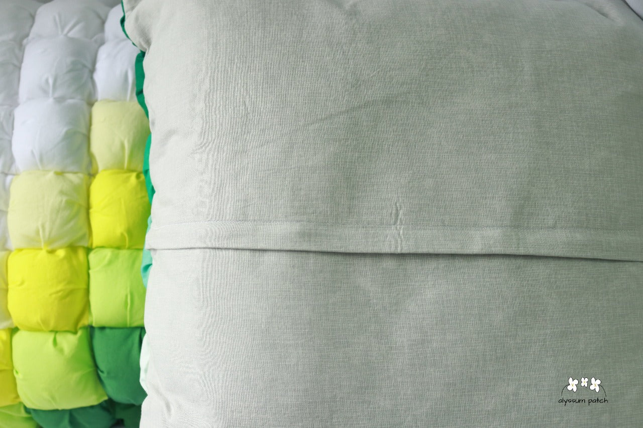 Back of Patchwork Puff Throw Pillow featuring zipper