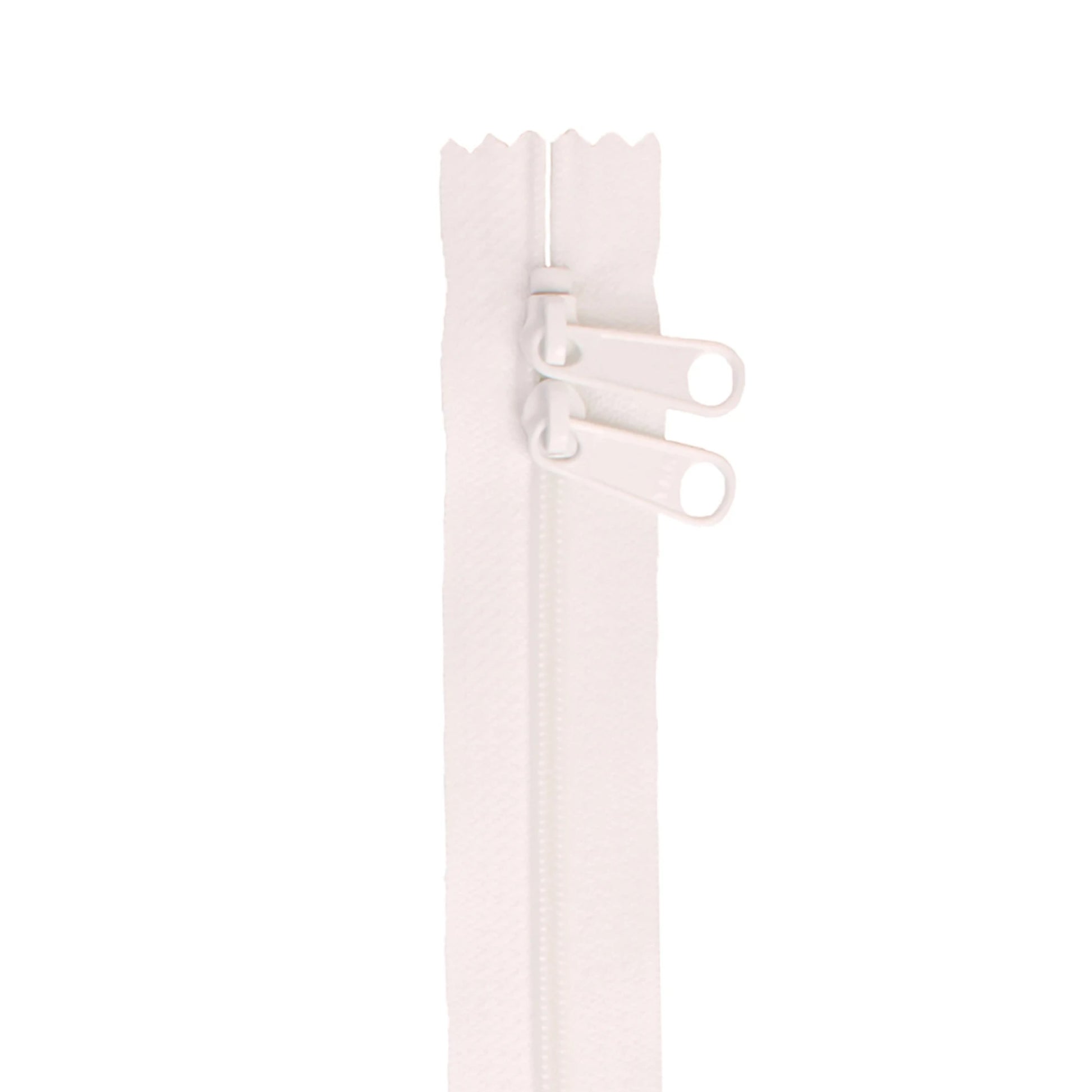 Close-up of a white zipper on a light pink background