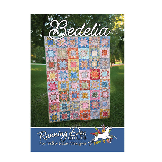 A quilt pattern cover for 'Bedelia' by Running Bee Quilts, featuring a colorful patchwork star quilt displayed outdoors on a green lawn. The bottom of the cover has a blue band with the brand logo and text 'For Villa Rosa Designs'.
