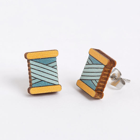 Wooden earrings with geometric pattern on a white background