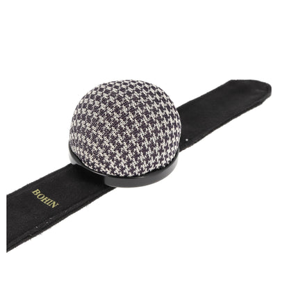 Black and white houndstooth patterned pincushion bracelet.