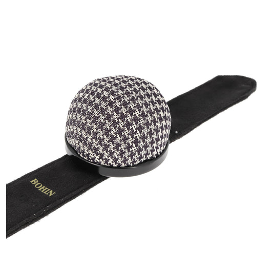 Black and white houndstooth patterned pincushion bracelet.