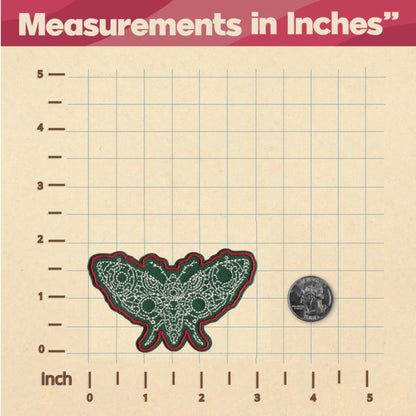 Green and red butterfly patch on a grid with measurements in inches