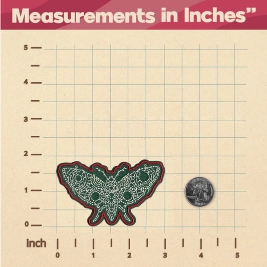 Green and red butterfly patch on a grid with measurements in inches