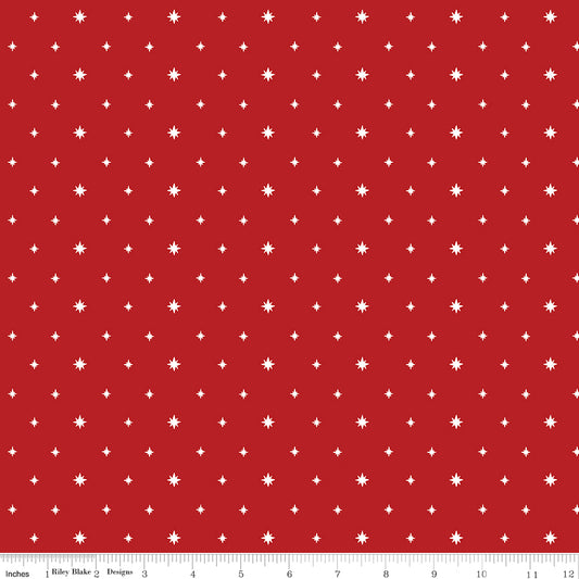 Red fabric with white star pattern and ruler at the bottom