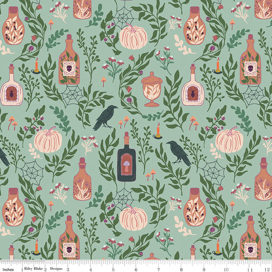 Halloween-themed fabric pattern with pumpkins, bottles, and leaves on a teal background.