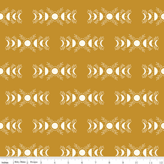 Patterned fabric with white design on a mustard yellow background