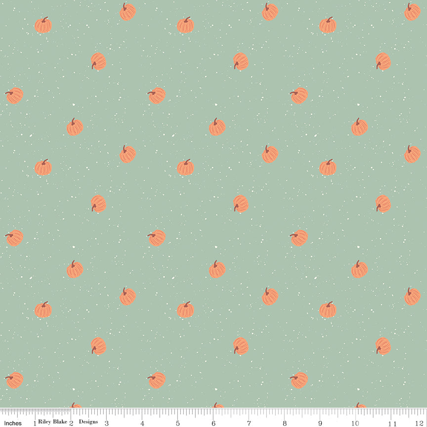 Pattern of small orange pumpkins on a light green background with white polka dots.