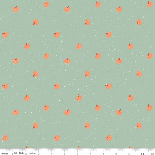 Pattern of small orange pumpkins on a light green background with white polka dots.
