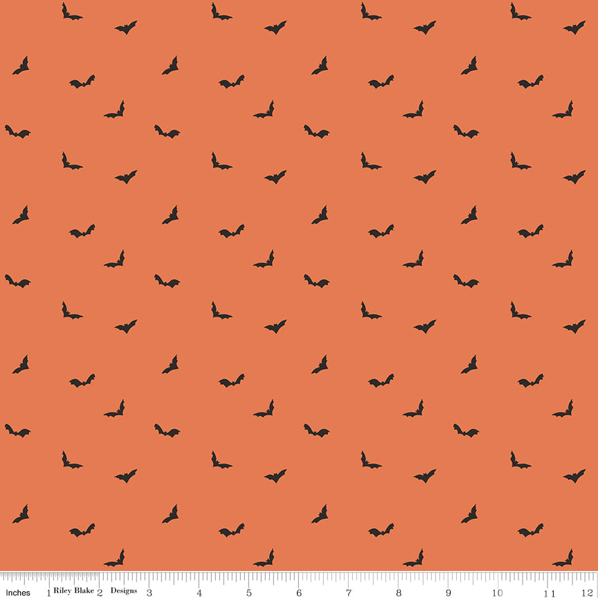 Pattern of small black bats on an orange background