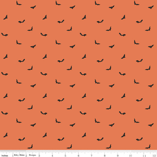 Pattern of small black bats on an orange background