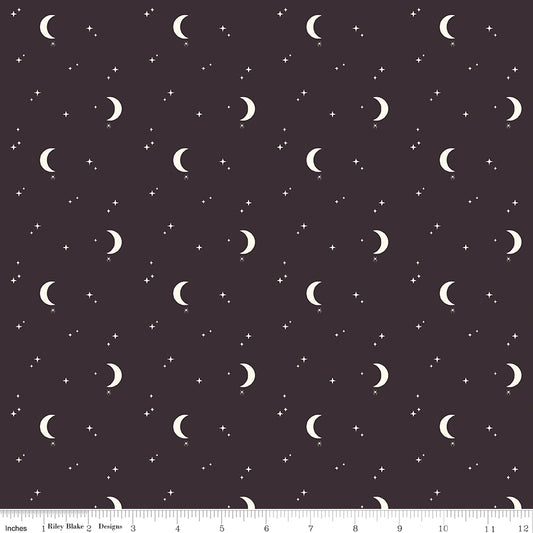 Pattern of crescent moons and stars on a dark background with a ruler at the bottom.