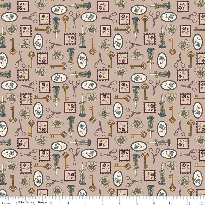 A repeating fabric pattern on a warm taupe background featuring vintage-style keys, scissors, framed floral motifs, and small botanical illustrations in muted blue, olive green, and brown. A white ruler along the bottom edge shows the scale of the print.