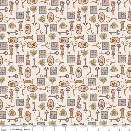 A repeating vintage-style pattern on a warm cream background featuring antique keys, scissors, hearts, and postage-style stamps in muted brown, dusty blue, sage green, and soft pink. A fabric ruler along the bottom edge shows the print scale.
