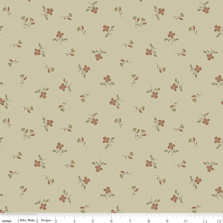 A repeating floral pattern on a warm beige background, featuring small reddish-brown flowers with muted green leaves and stems. A fabric ruler is visible along the bottom edge for scale.