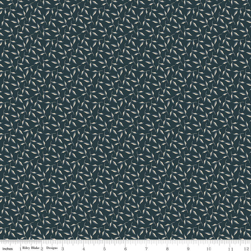A close-up of a fabric pattern featuring a dense, repeating design of small white and light gray leaves on a dark slate blue background, with a ruler at the bottom indicating scale.